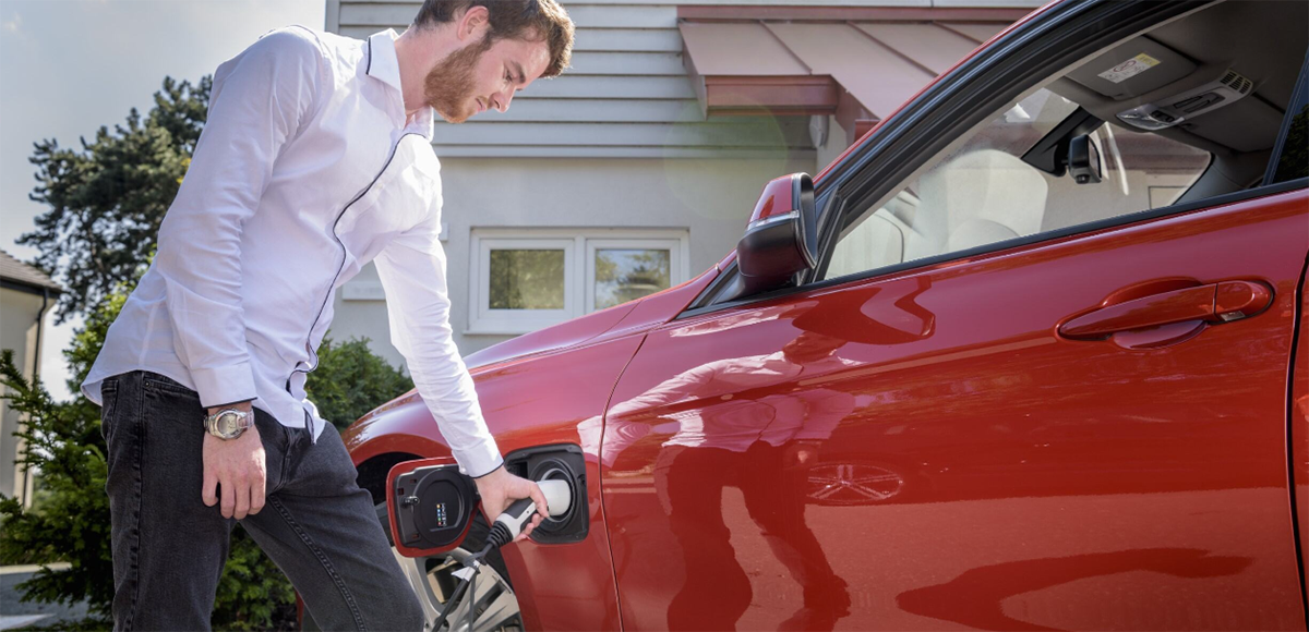 man charging EV at home | CB | 1200x580