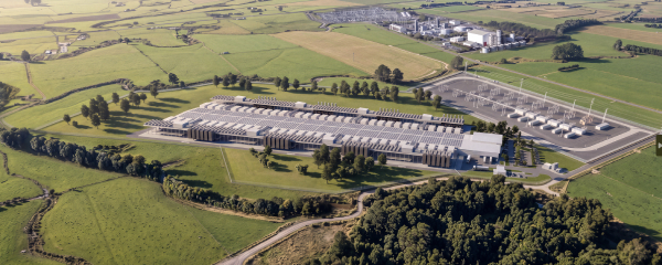 Aerial view of the potential data centre surrounded by green farmland, showing the main facility building and rows of cooling equipment